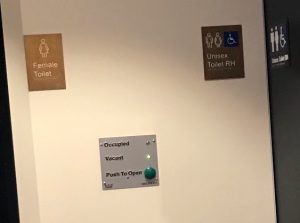 the automated doors of the accessible toilets inclues a button that opens the door and a vacant light