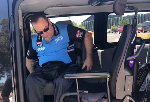 I am in my van, and in the driver's seat. My empty wheelchair is next to me