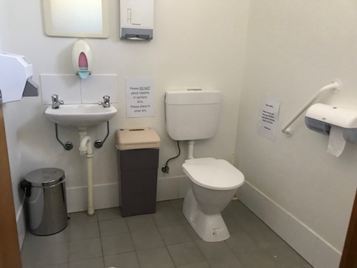 inside the toilet - a mirror high on the wall, as is the paper dispenser. Very tight area