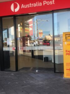 the front doors of the PO area - a new shiney sliding see through door