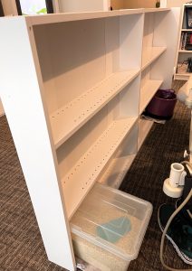 the bookcase has two heavy objects to stop it falling over